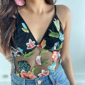Black mesh top with flowers details. Size small. Model wearing size Small.